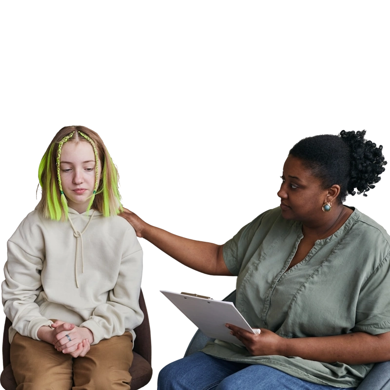 A supportive counseling session featuring a person with green-streaked hair sitting thoughtfully while a counselor with a clipboard offers a comforting hand on their shoulder, highlighting the importance of mental health support for transgender individuals.