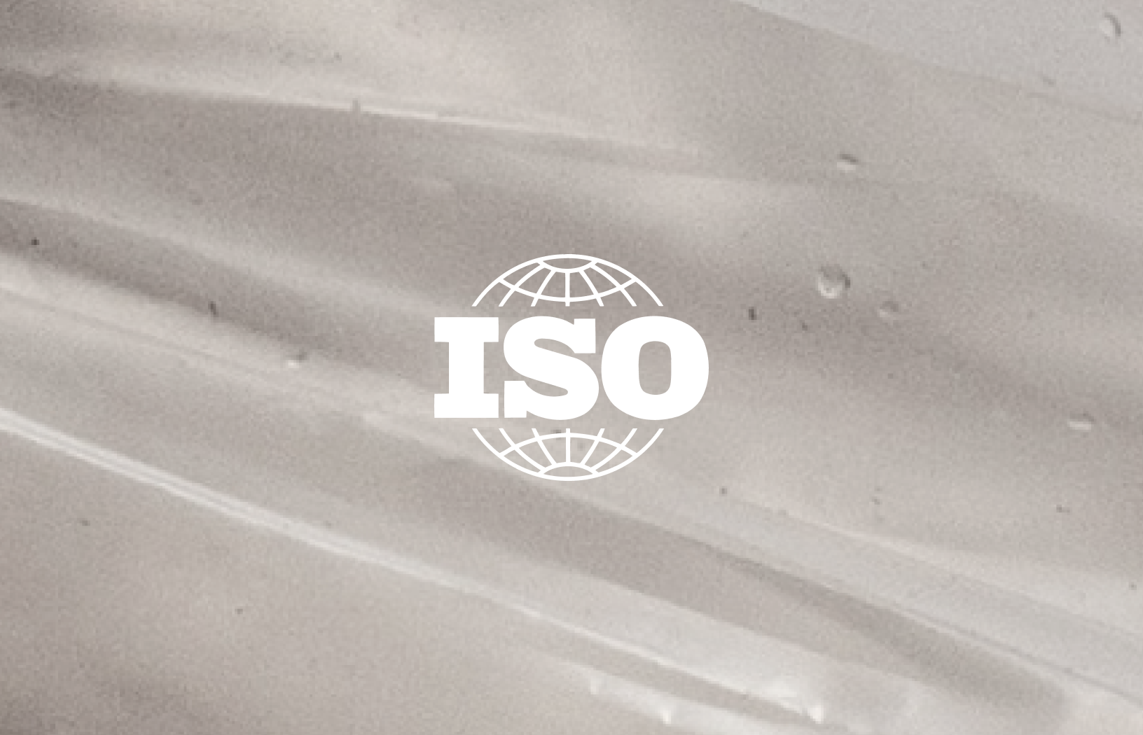 ISO logo over a translucent recyclable plastic surface, representing Grounded's ISO-accredited life cycle assessment