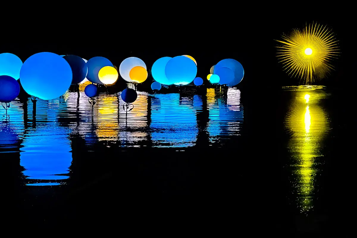 Bronx Botanical Garden,  blue and yellow round lights  with their reflections in water