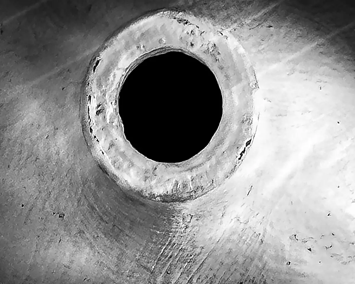 close up of a clay jug in black and white