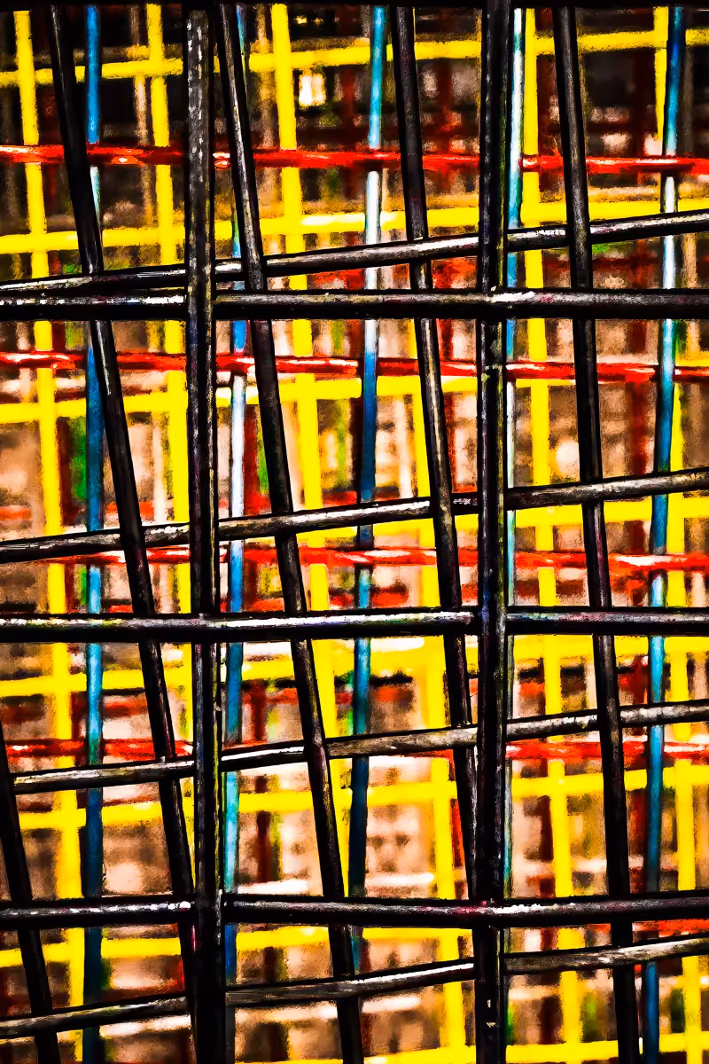 close up of multiple tennis racquet strings of different colors to form abstract pattern
