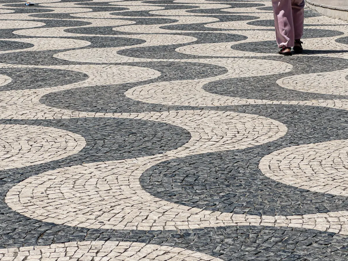Portugal: patterned stone ground with a single person walking