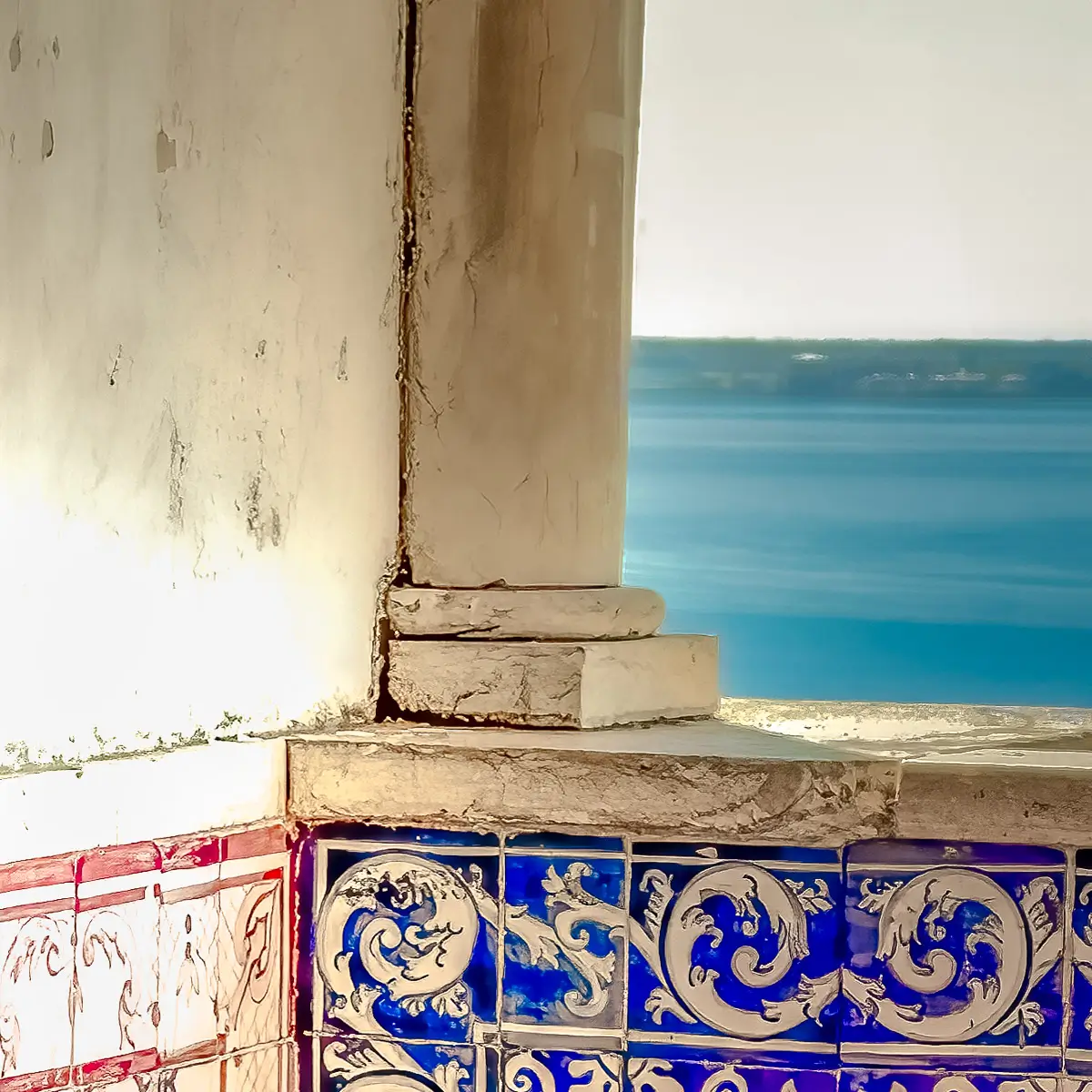Portugal, looking out a corner to the sea with tiled walls and stone column