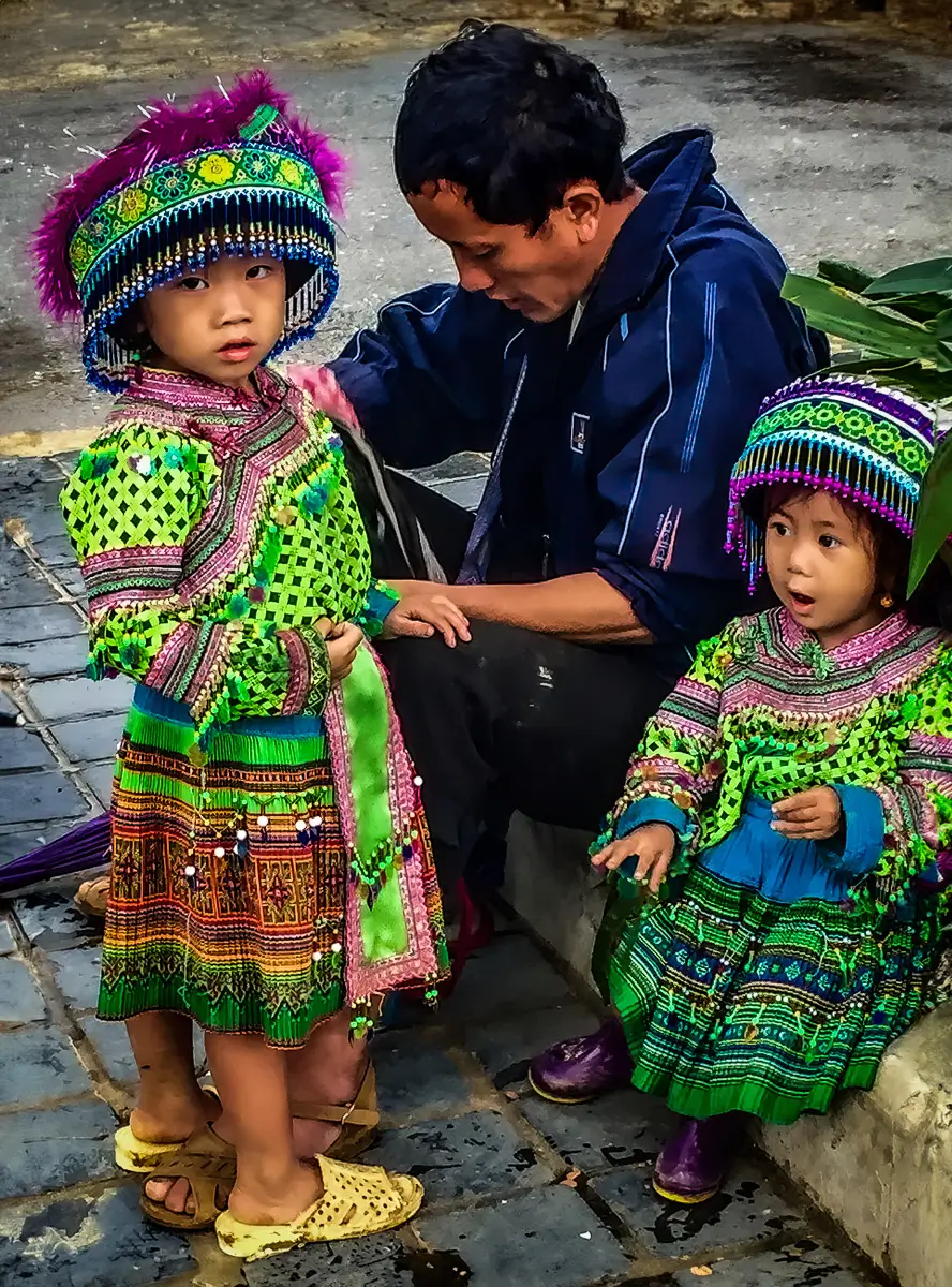 Vietnam: Man with 2 daughters dressed in traditional dress for a ceremony