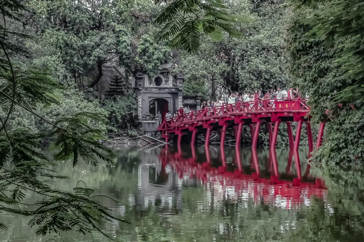 Vietnam: red bridge amongst trees