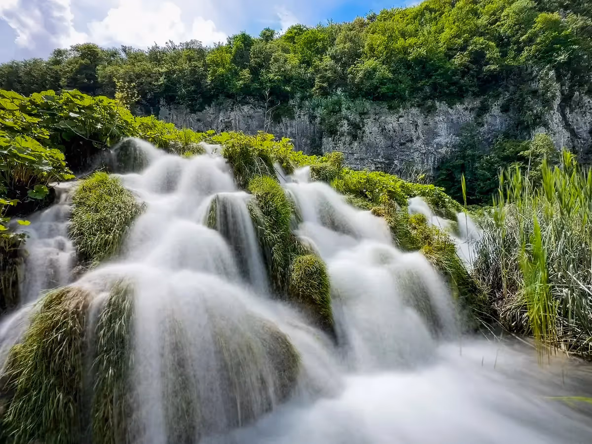 Plitvice National Park in Croatia, slow shutter speed to show beautiful flowing water of the waterfalls through the brush
