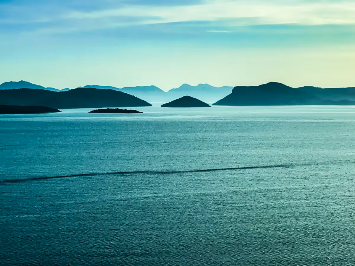 Croatia: silhouette of islands at dusk across the water