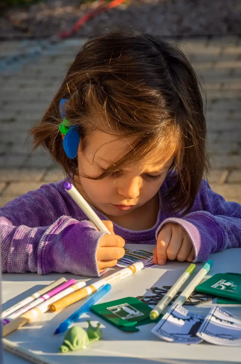 Young girl drawing at a fair