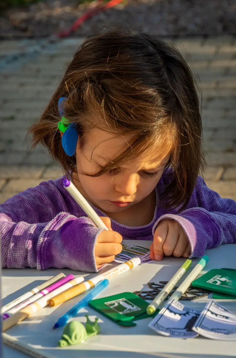 Young girl drawing at a fair