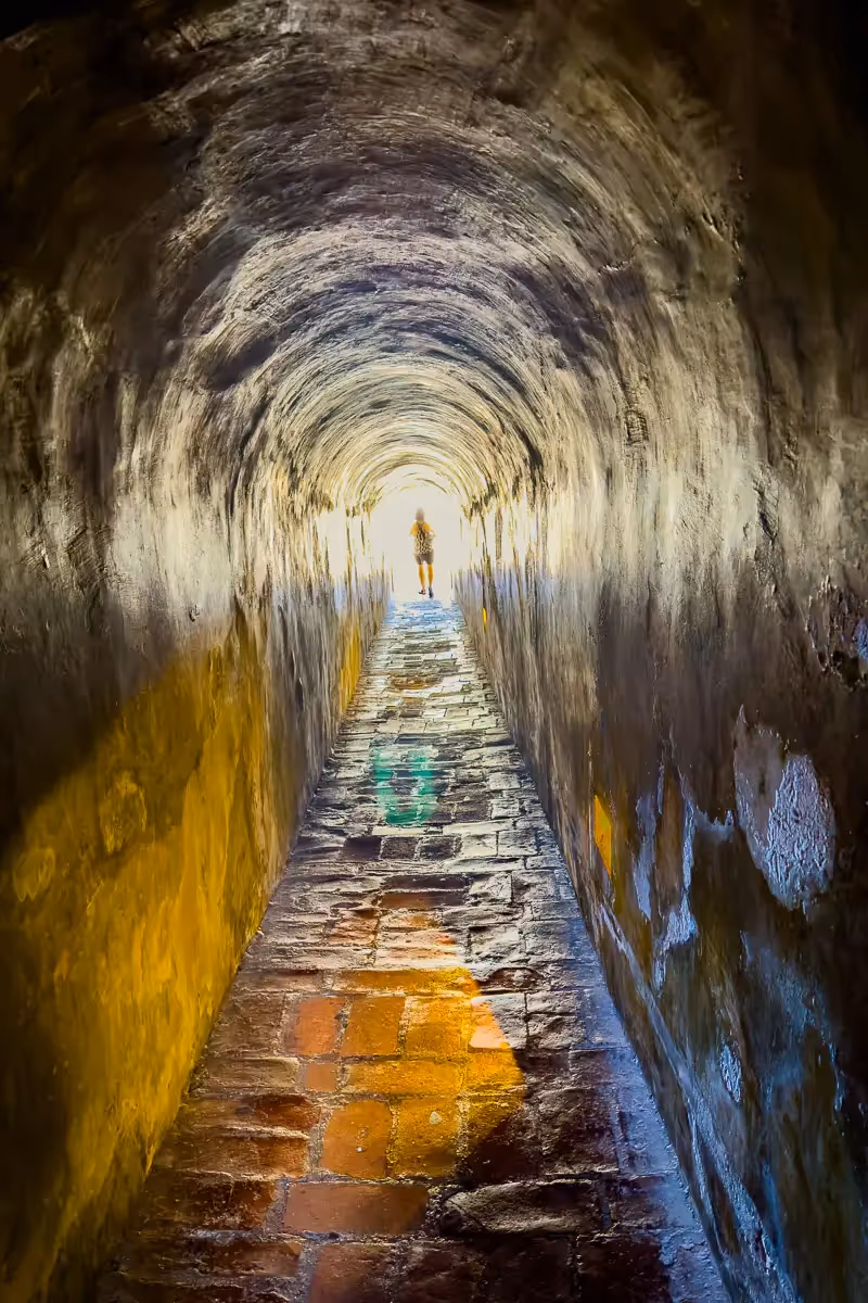 Cartagena, person walking into the light through a golden tunnel