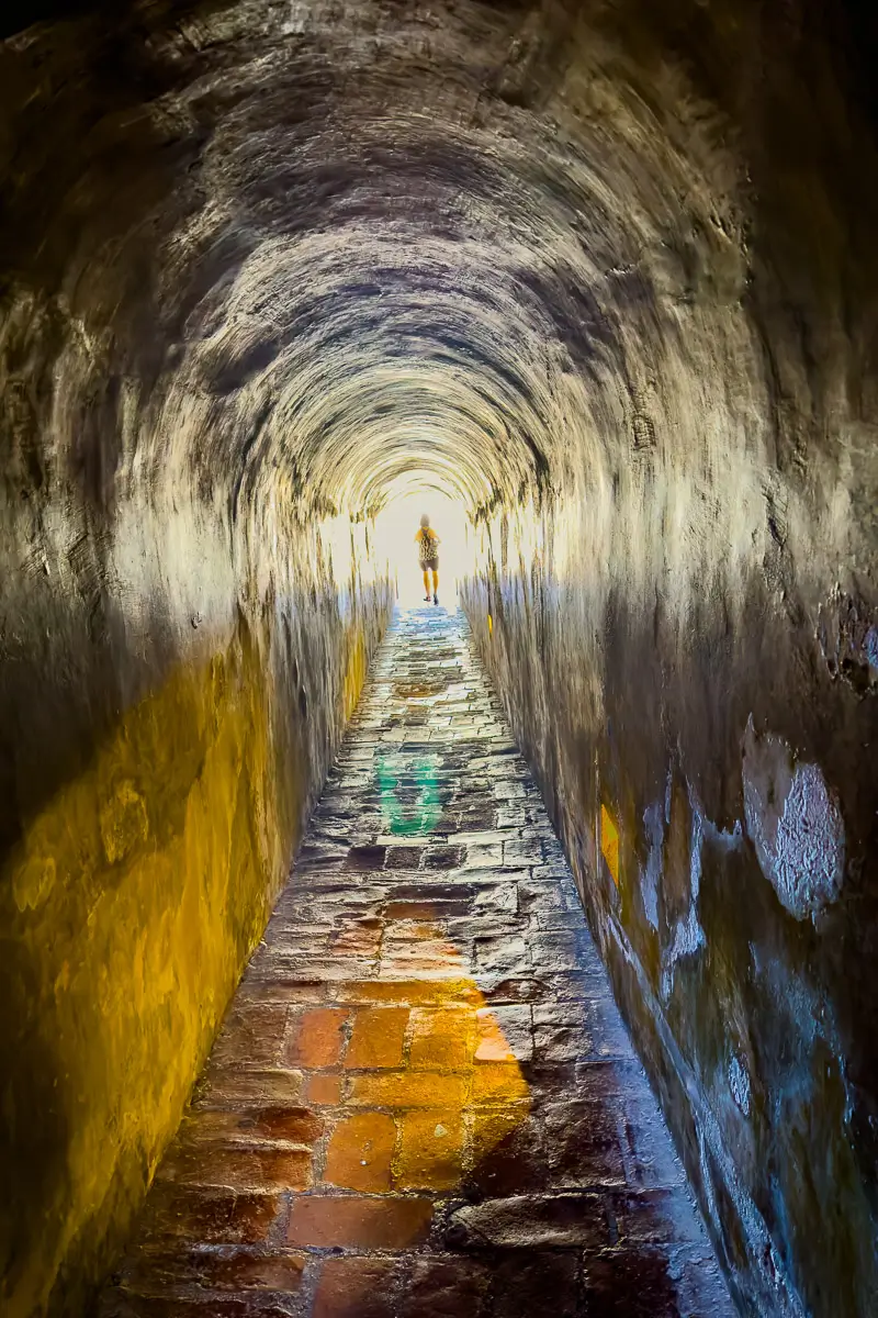 Cartagena, person walking into the light through a golden tunnel