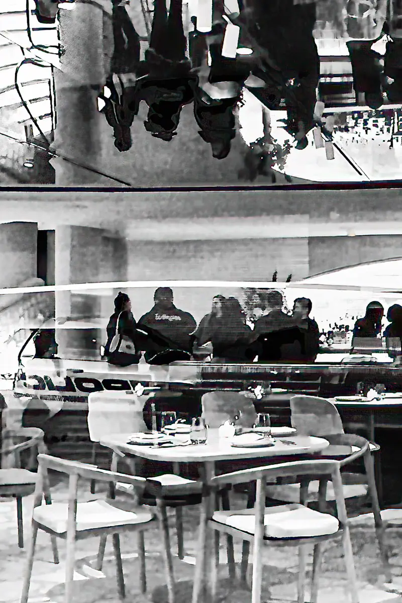 NYC black and white reflection of people at a bar