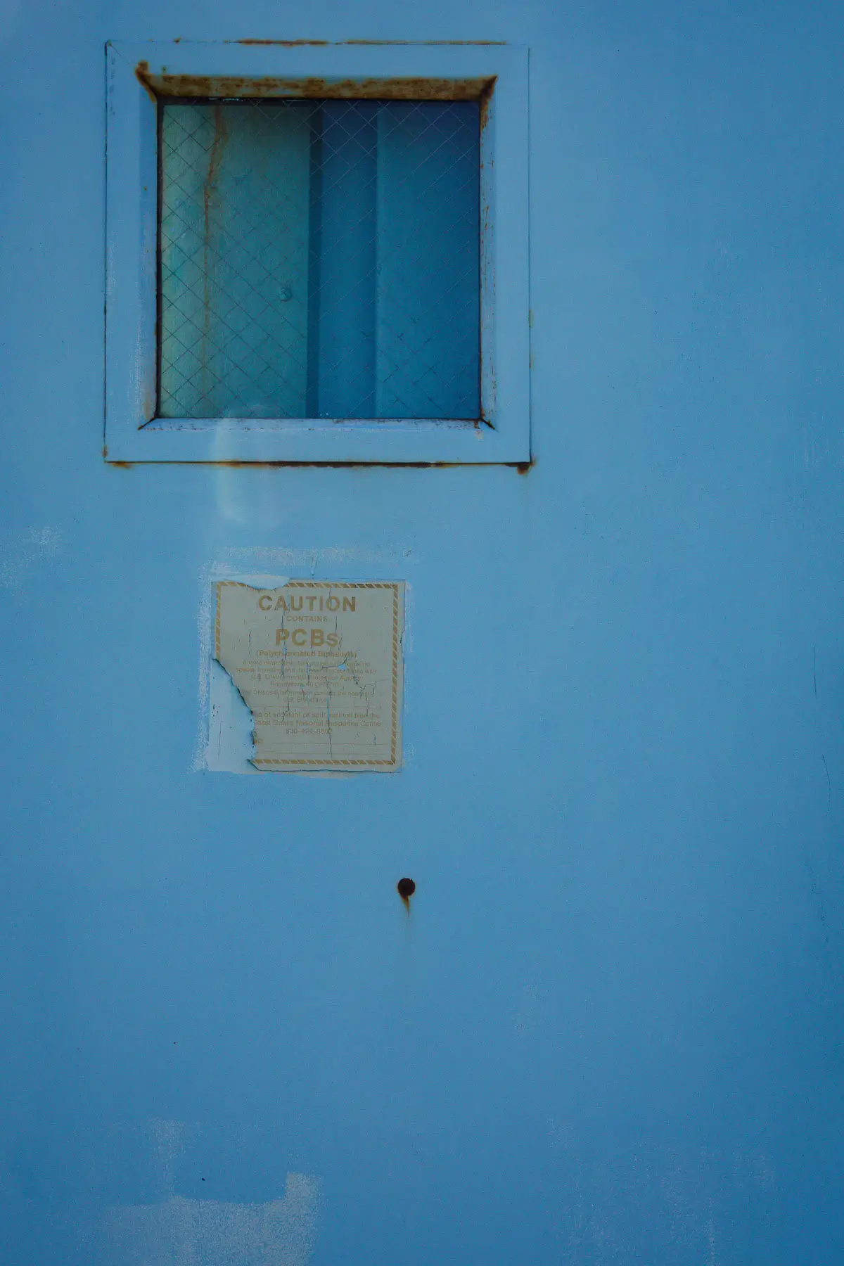 Manresa Island Power Plant: abstact, rust, peeling paint, shadows, light, blue door with square window