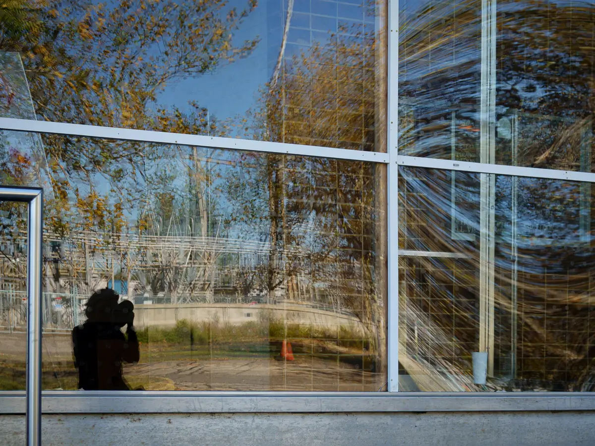 Manresa Island Power Plant: shadow of photographer in window with reflection of trees