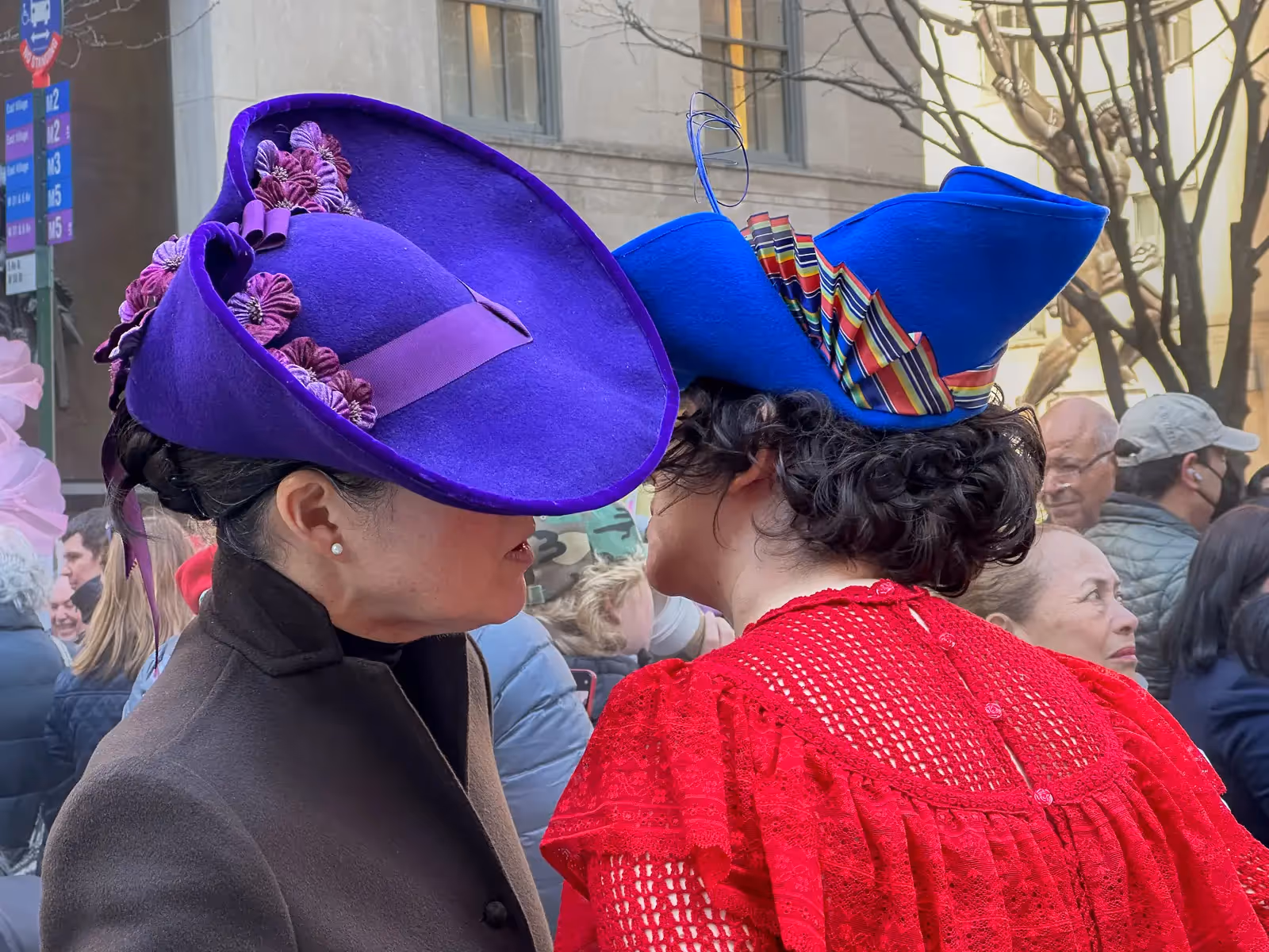 2024 Easter Bonnet Parade, NYC:  2 women whispering