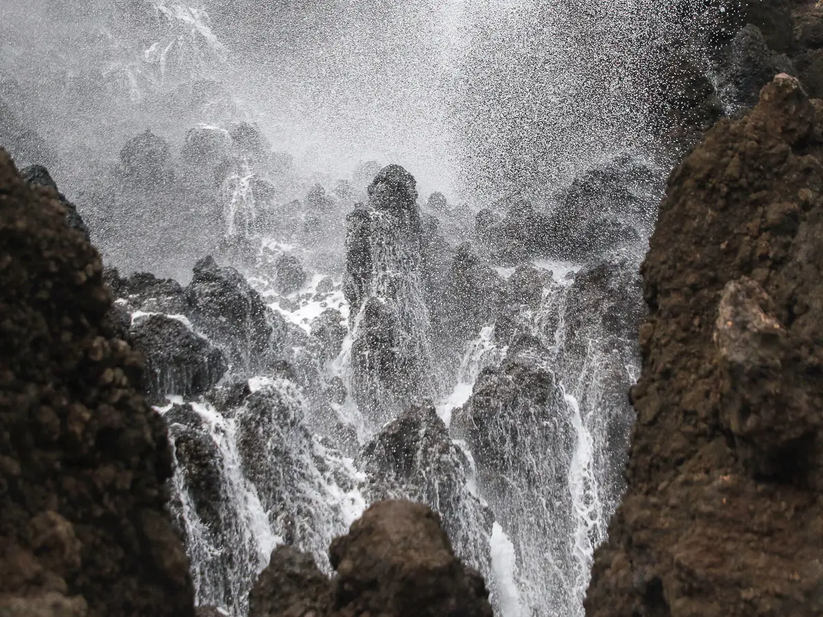 Hawaii blow hole, water spray and landing across large rock formations