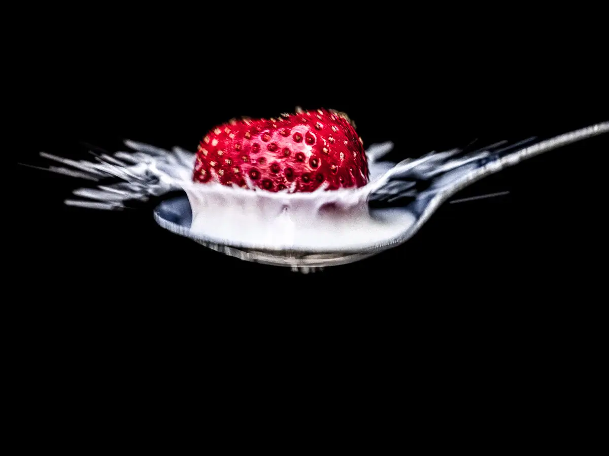 milk crown in spoon from splashing strawberry