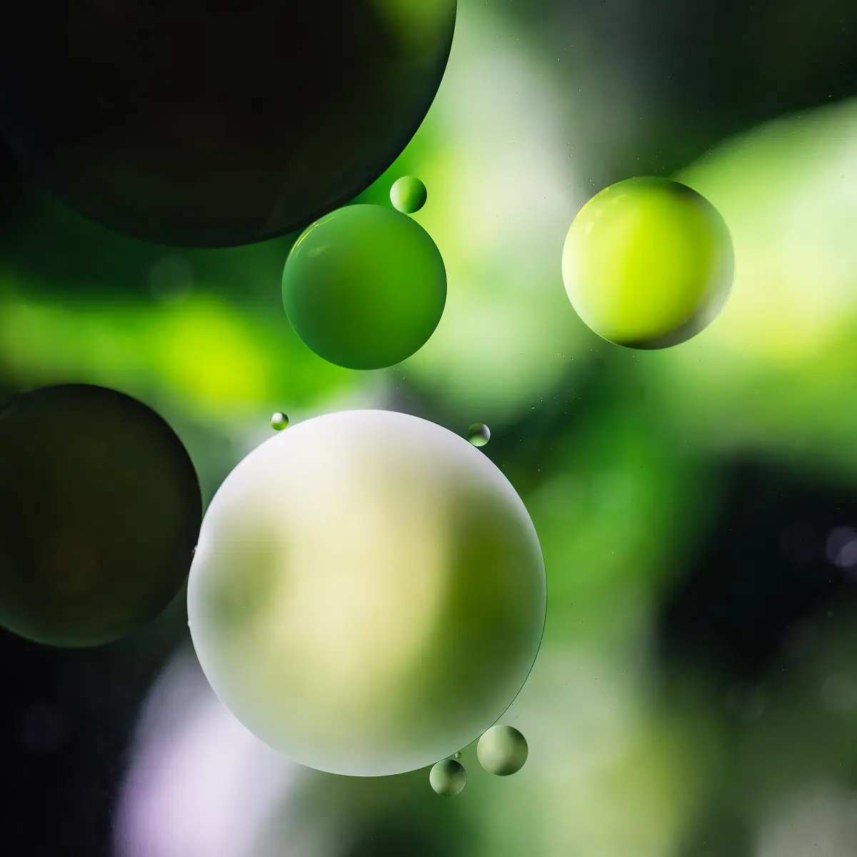 Immiscible: abstract of oil and water with a colorful background. Green