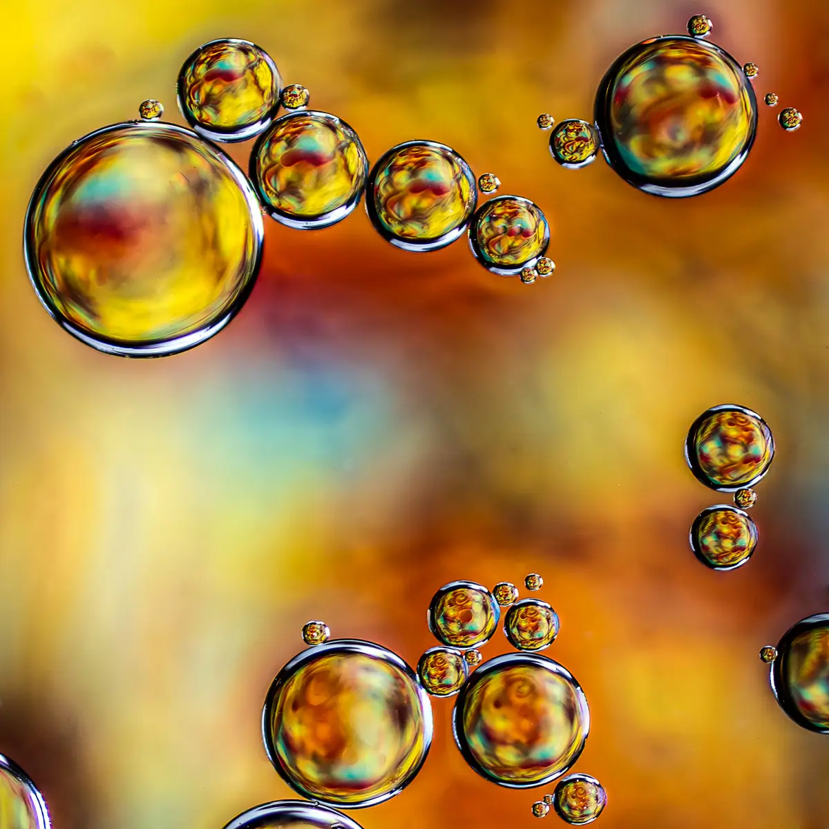 Immiscible: abstract of oil and water with a colorful background. Yellow and orange
