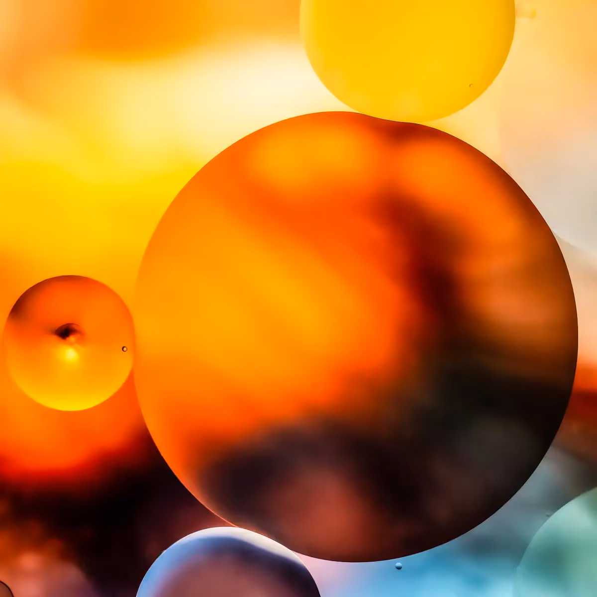 Immiscible: abstract of oil and water with a colorful background.  Orange