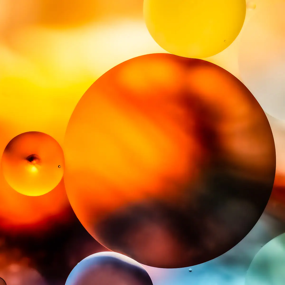 Immiscible: abstract of oil and water with a colorful background.  Orange