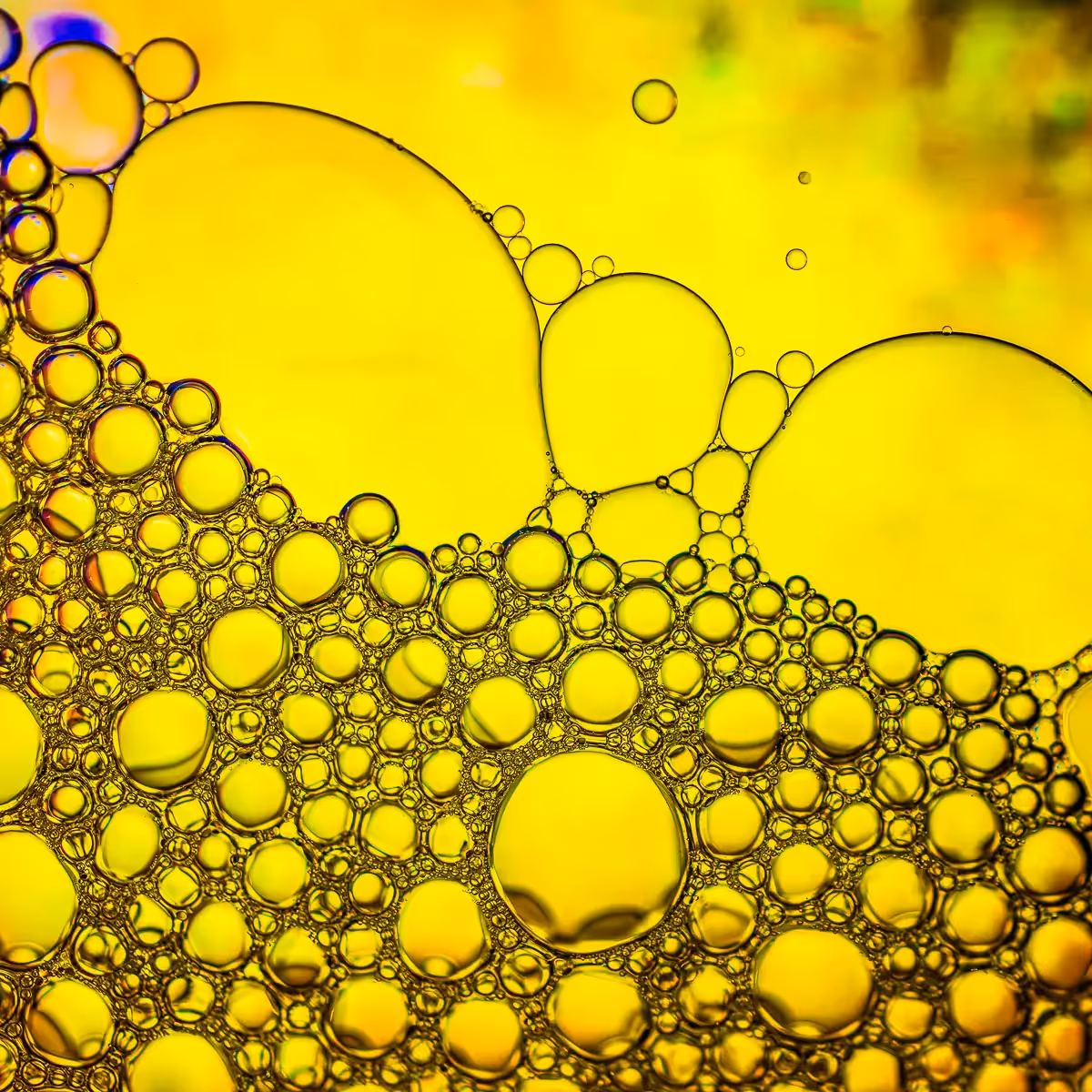 Immiscible: abstract of oil and water with a colorful background.  Yellow