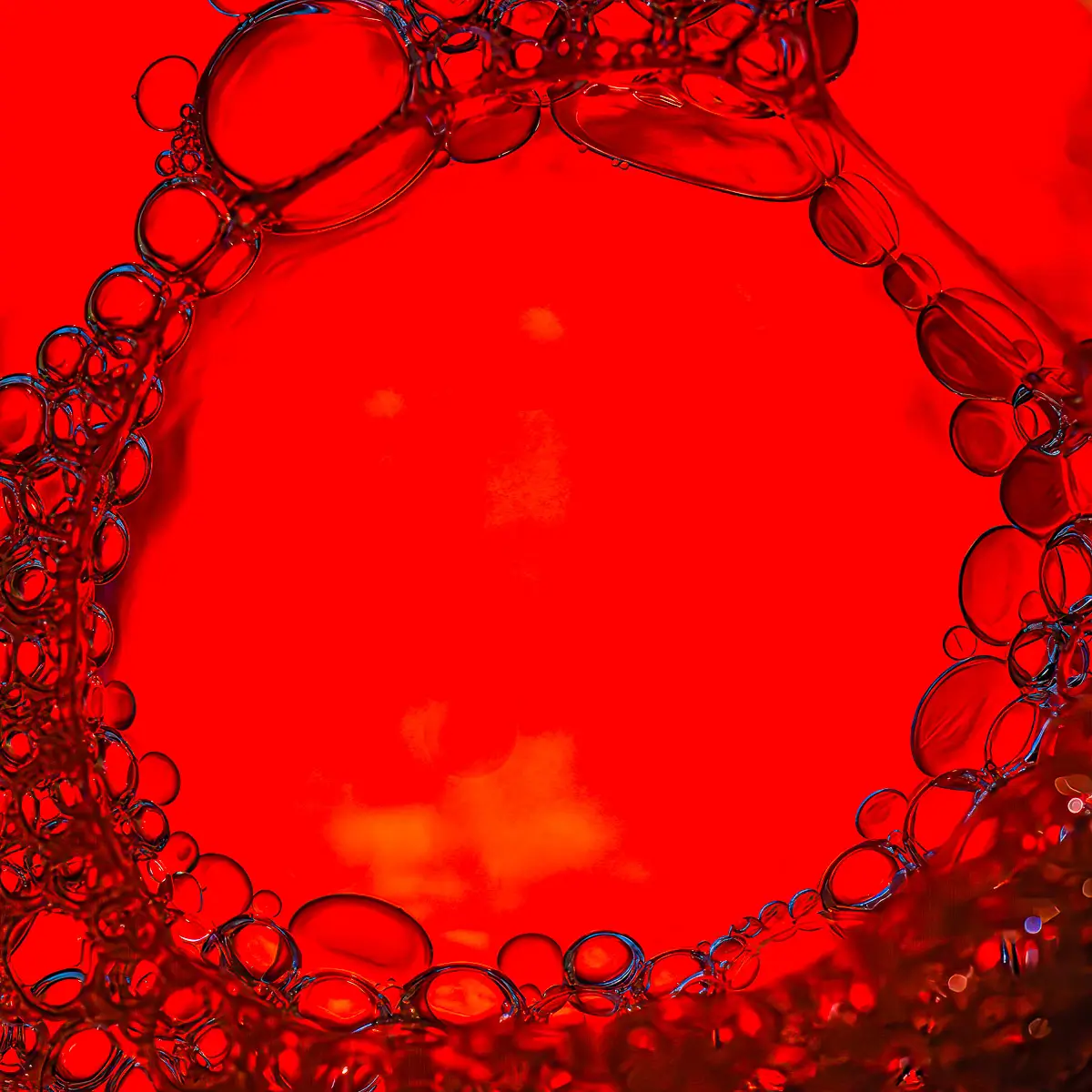 Immiscible: abstract of oil and water with a colorful background.  Red