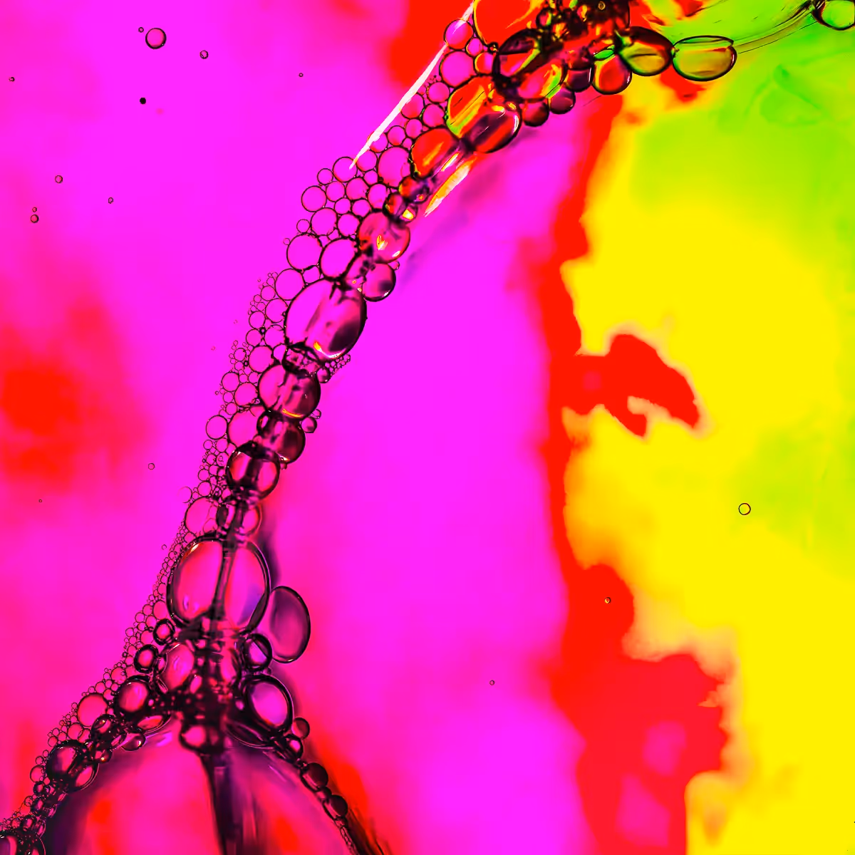 Immiscible: abstract of oil and water with a colorful background.  Pink and yellow