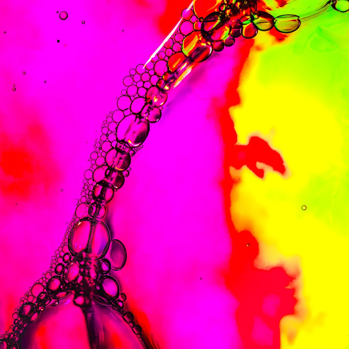 Immiscible: abstract of oil and water with a colorful background.  Pink and yellow