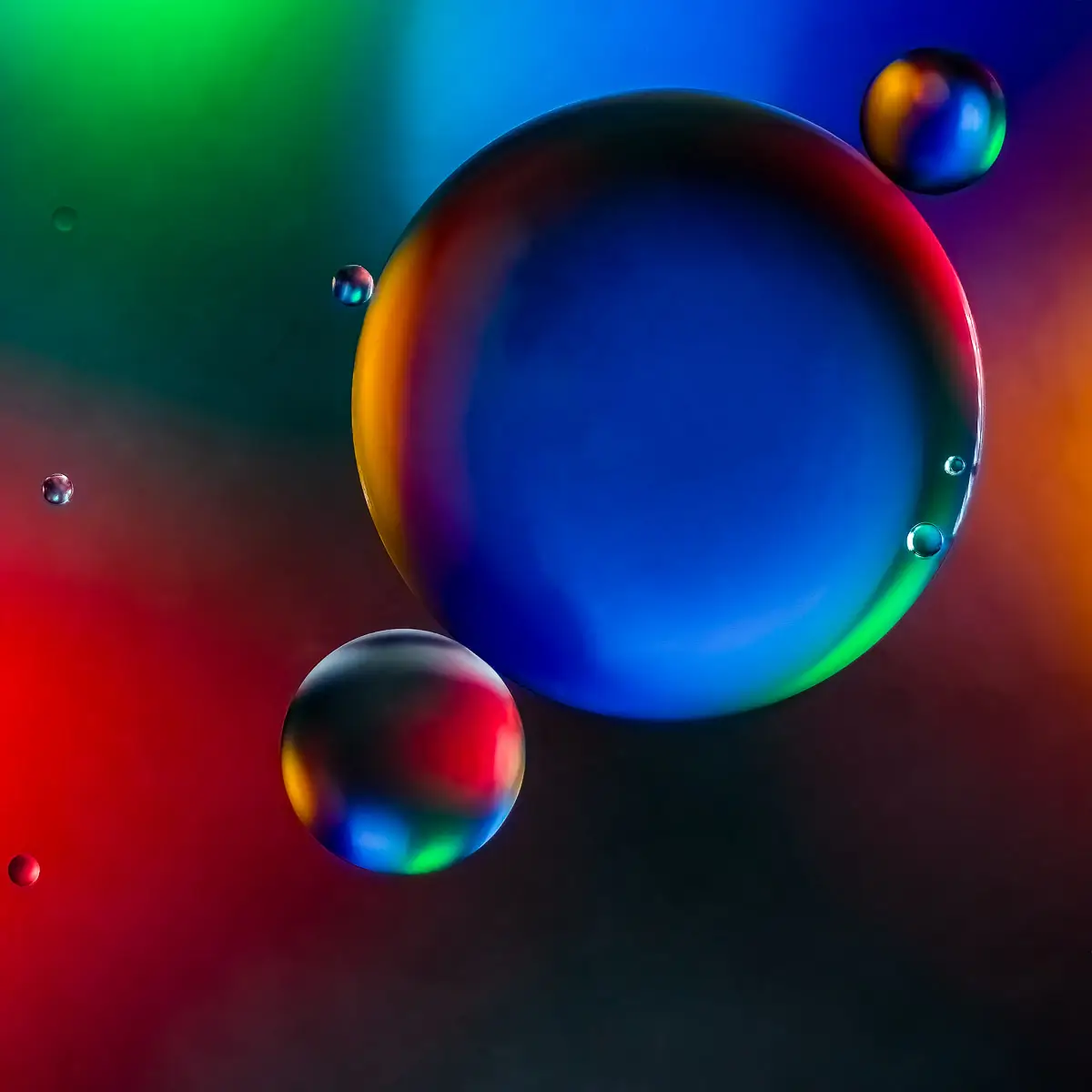 Immiscible: abstract of oil and water with a colorful background.  Planetary