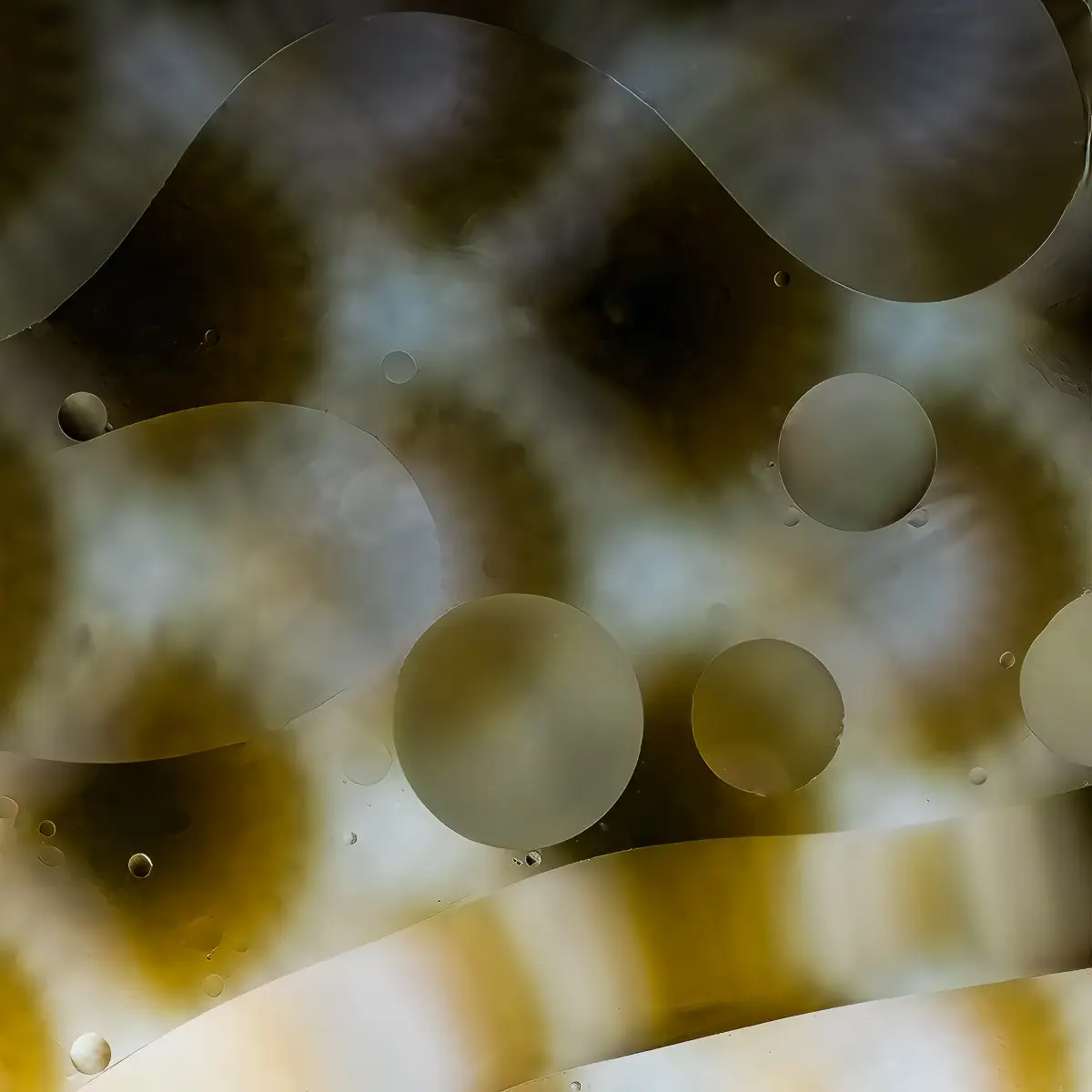 Immiscible: abstract of oil and water with a colorful background.  Brown and white