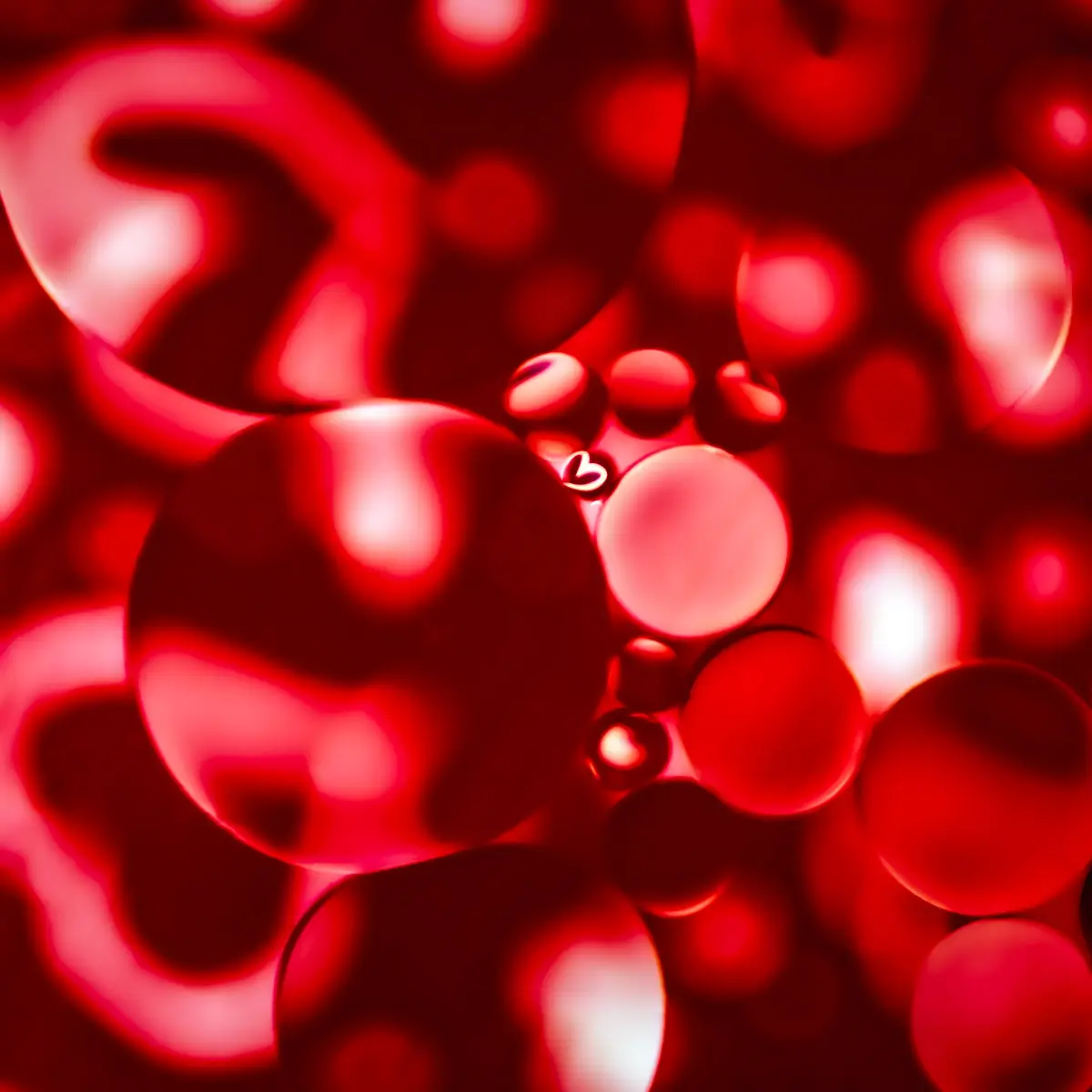 Immiscible: abstract of oil and water with a colorful background.  Red, white and black
