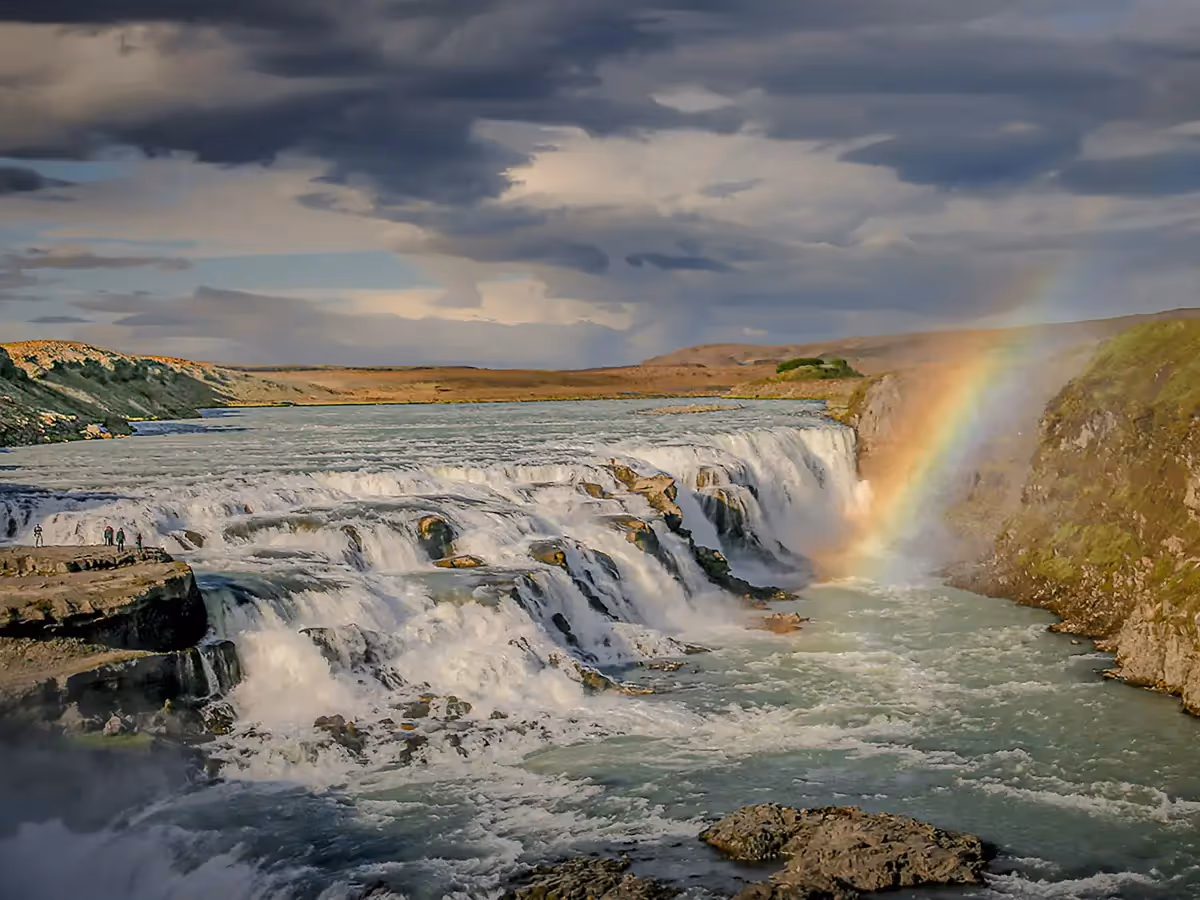 River expanse with a rainbow over a beautiful waterfall