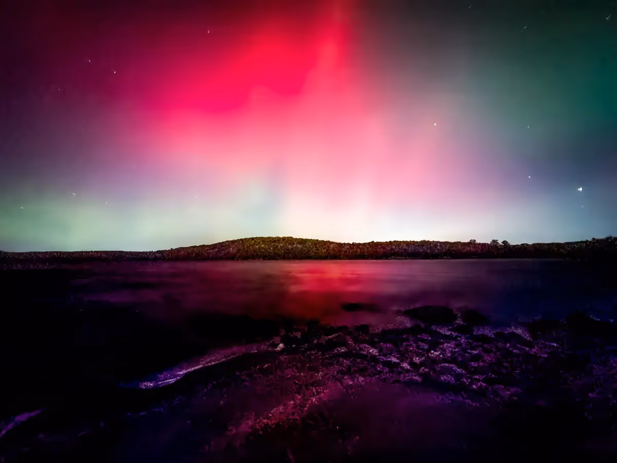 Aurora Borealis of pink and green over Reservoir in Weston, CT