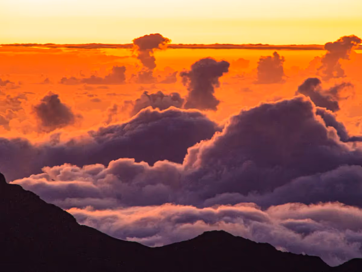 Above the clouds during sunrise on the top of Haleakala volcano in Hawaii