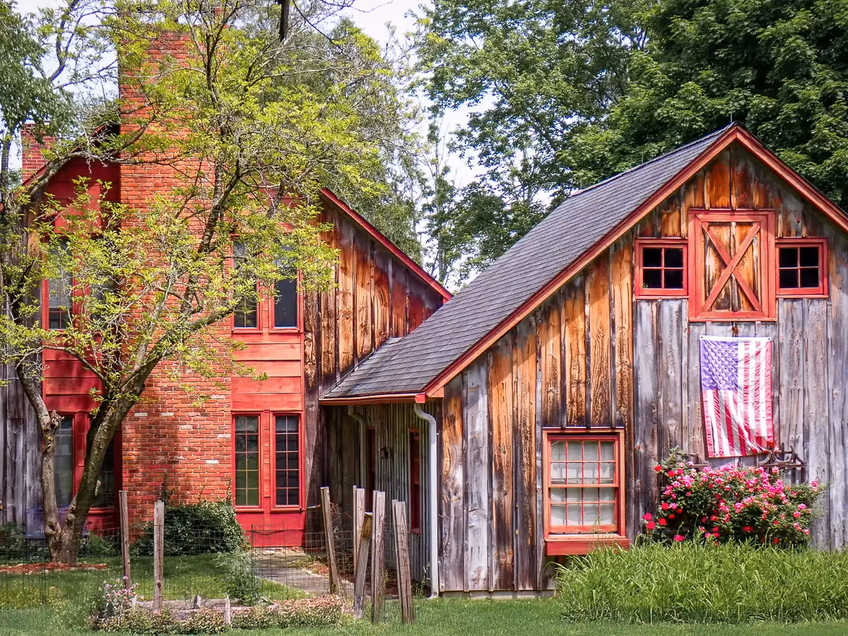  red barn house and garage with American Flag hanging