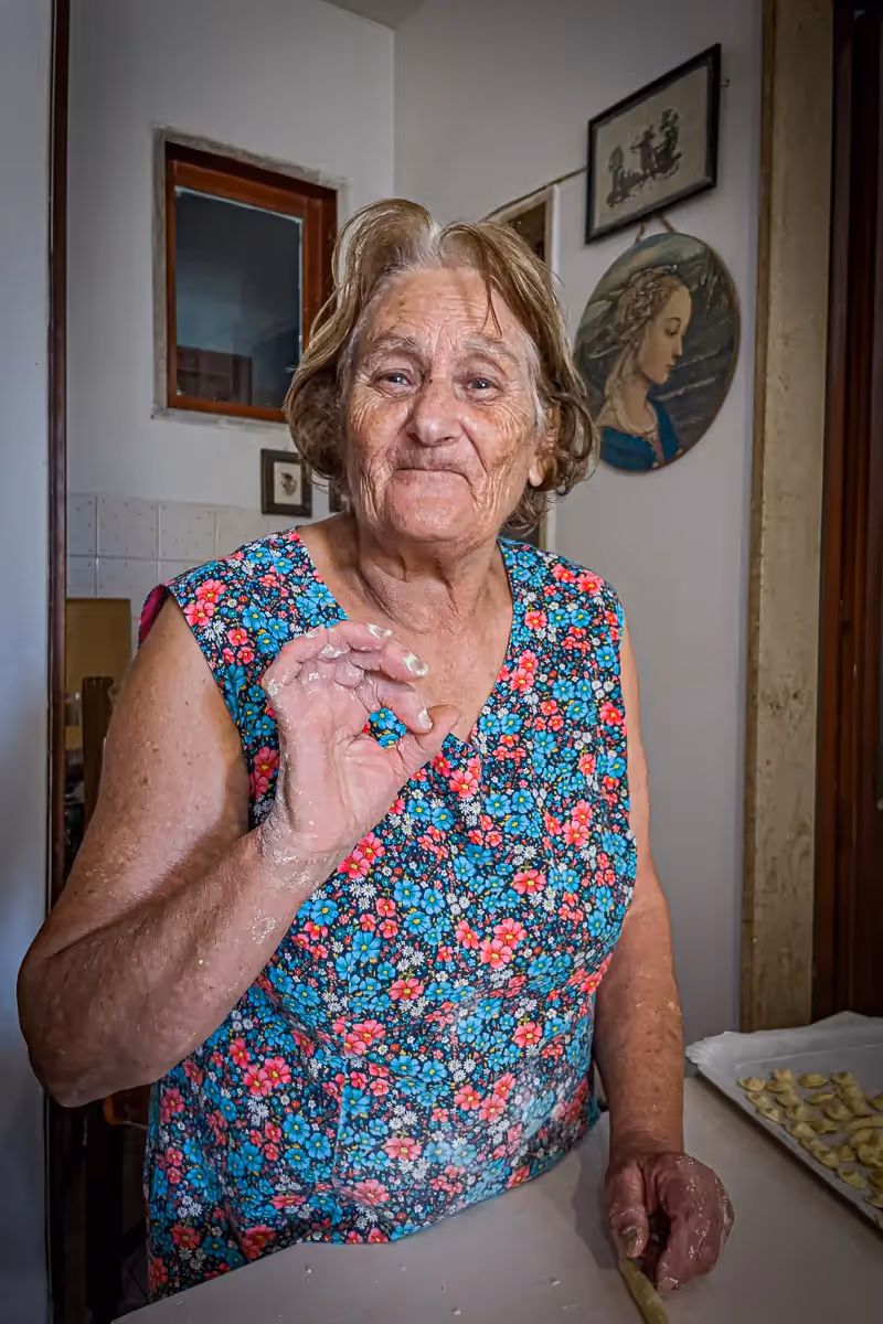 Italian chef explaining how to make pasta in her home kitchen