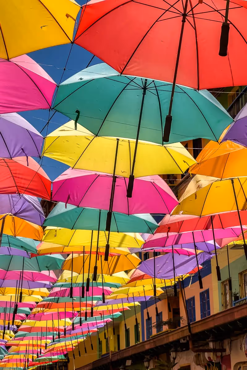 Colombia: street lined with colorful umbrellas hanging form a ceiling