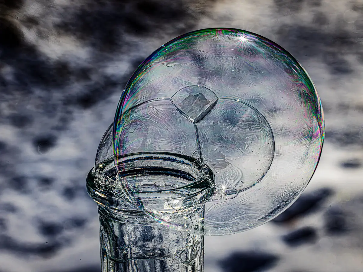 triple bubbles on top of a glass bottle, starting to freeze