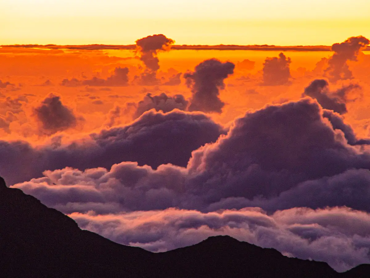 Above the clouds during sunrise on the top of Haleakala volcano in Hawaii