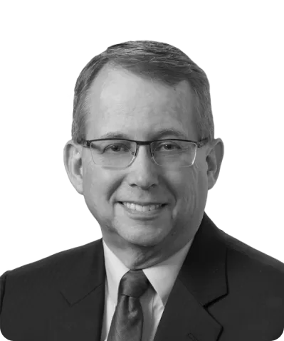 a black and white photo of a man in a suit and tie