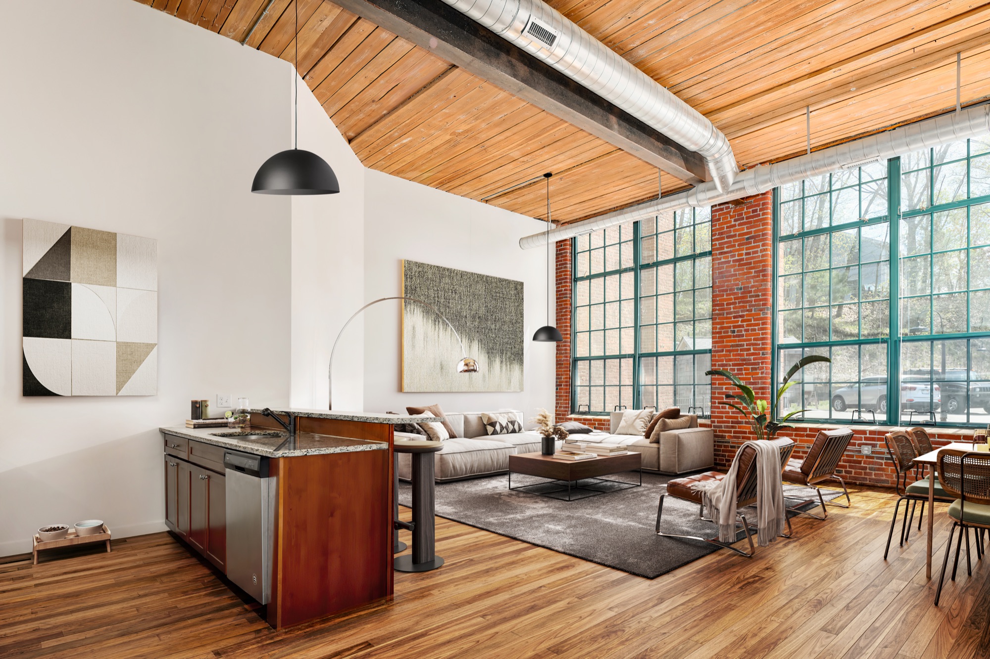 Open loft apartment with timber ceiling and tall steel windows