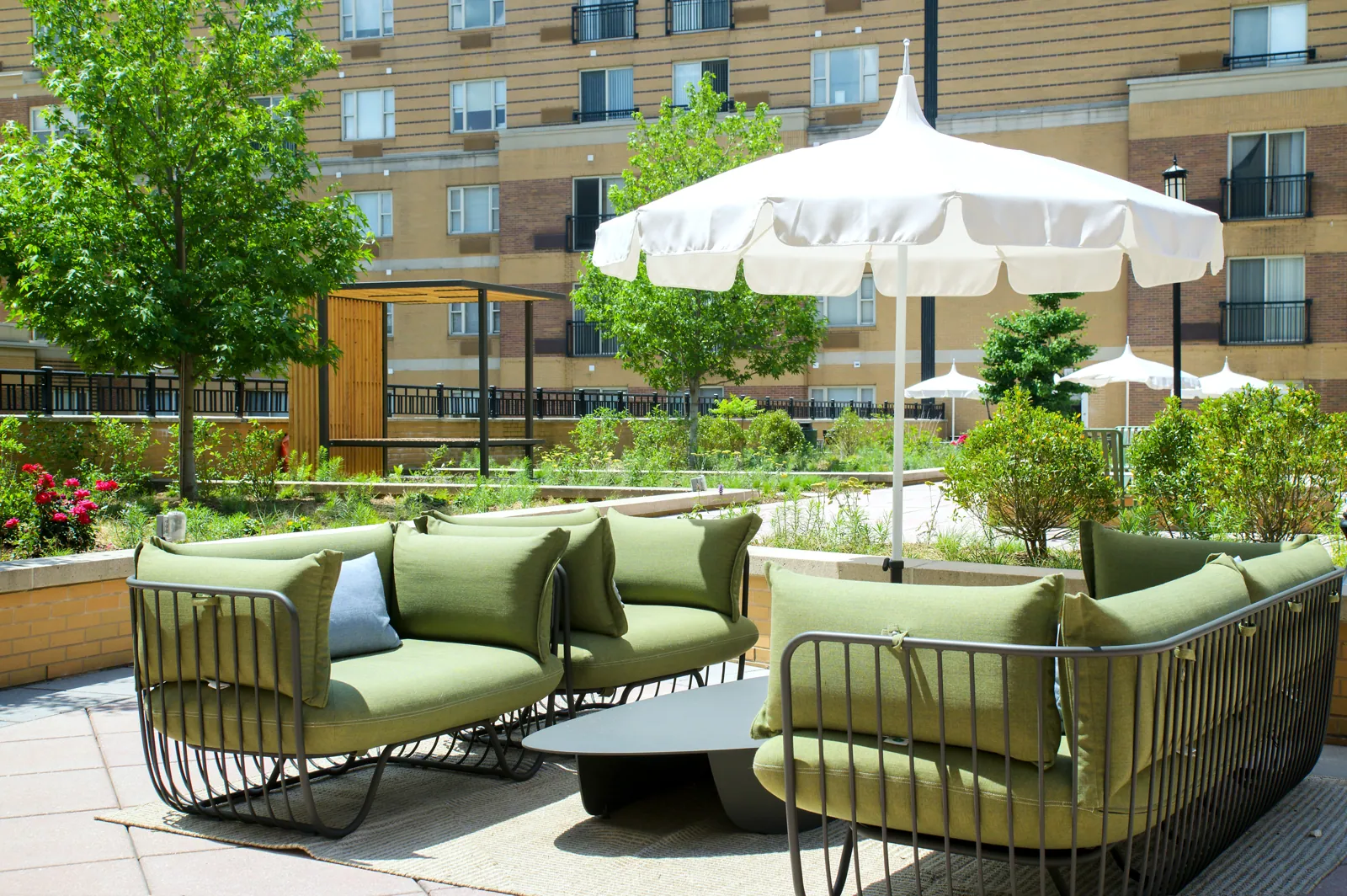 Rooftop terrace with green lounge chairs and parasols