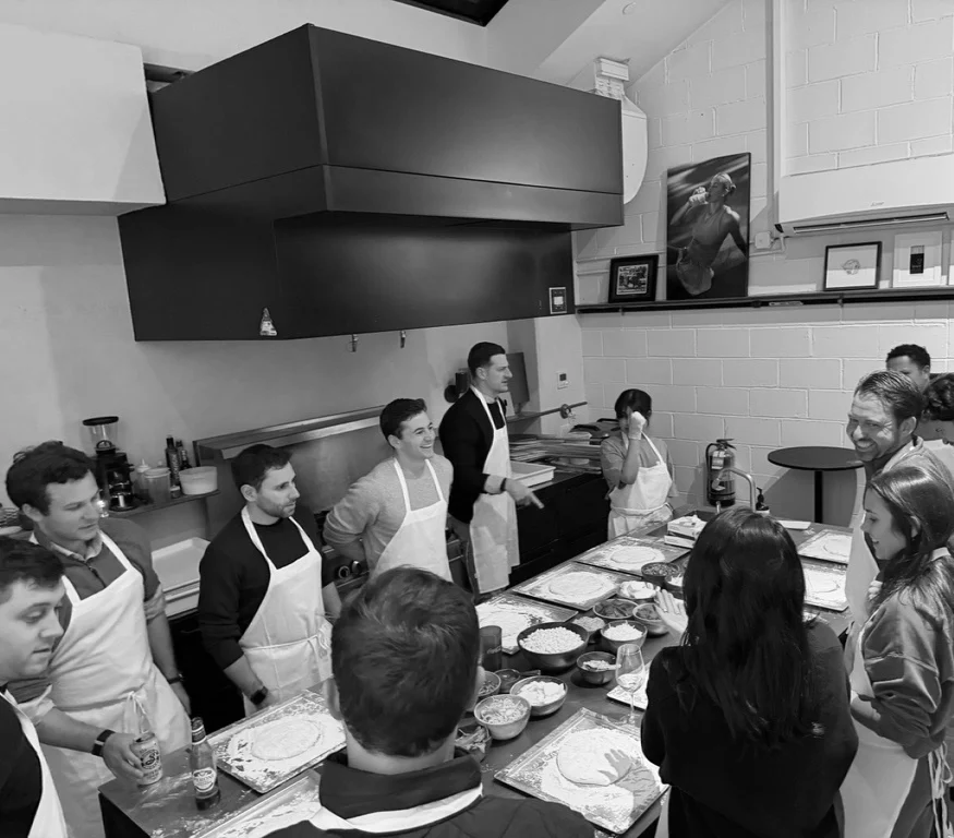 Team members in aprons at a cooking class