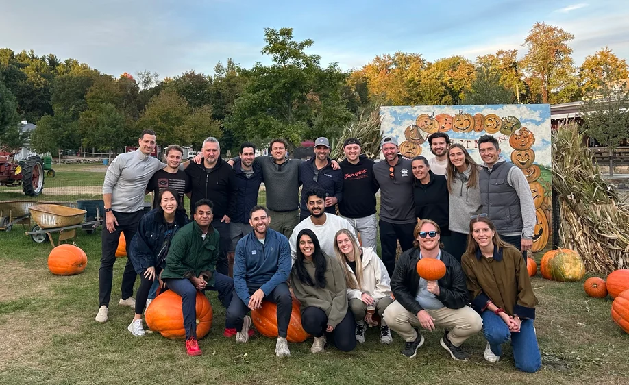 The Aker team together at a pumpkin farm in autumn