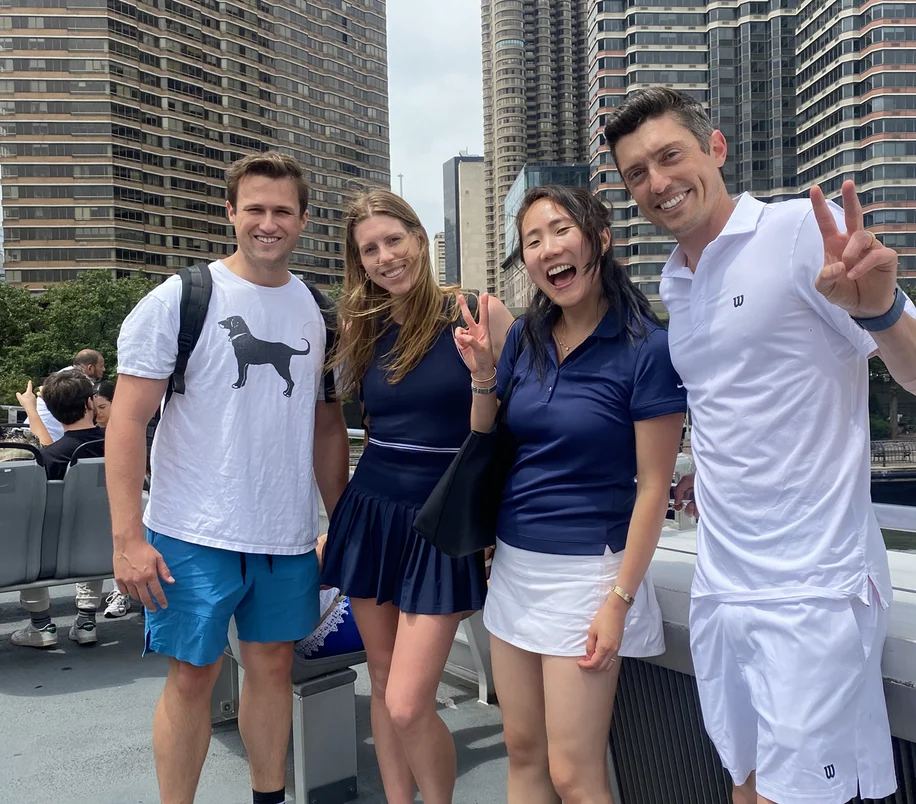 Colleagues smiling together on a city rooftop