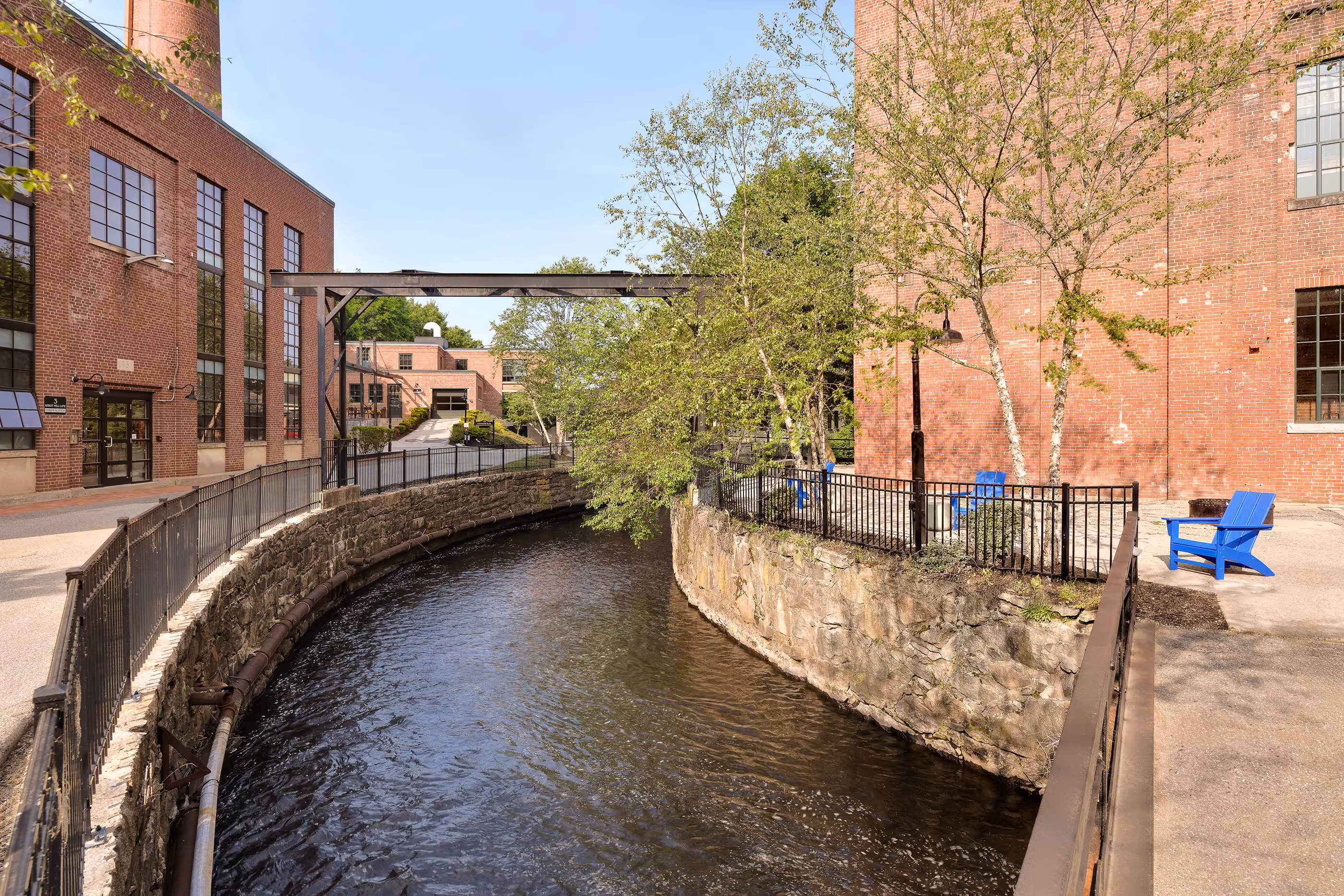 Landscaped courtyard between brick residential buildings