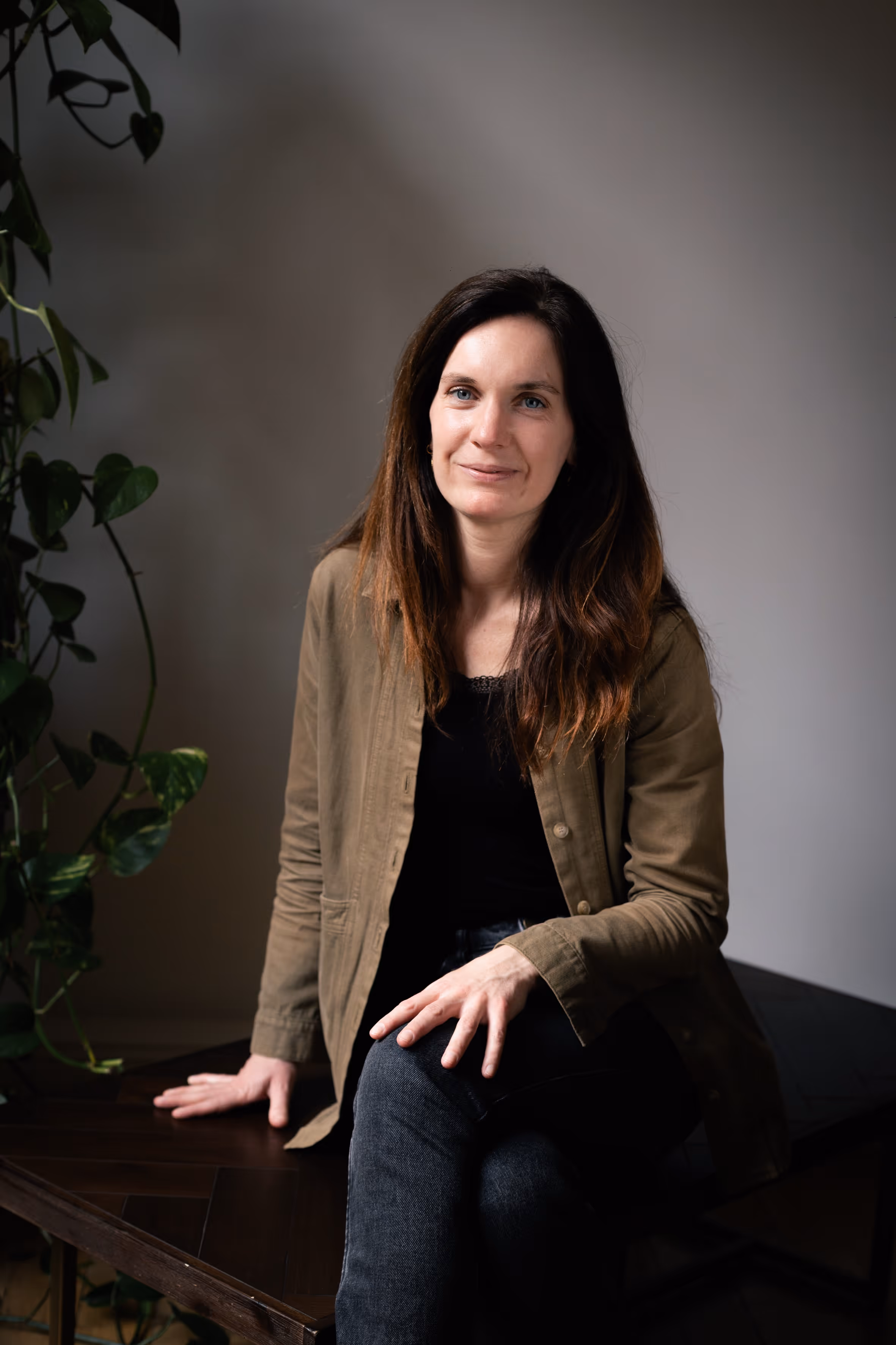 A portrait of a woman sitting and smiling.