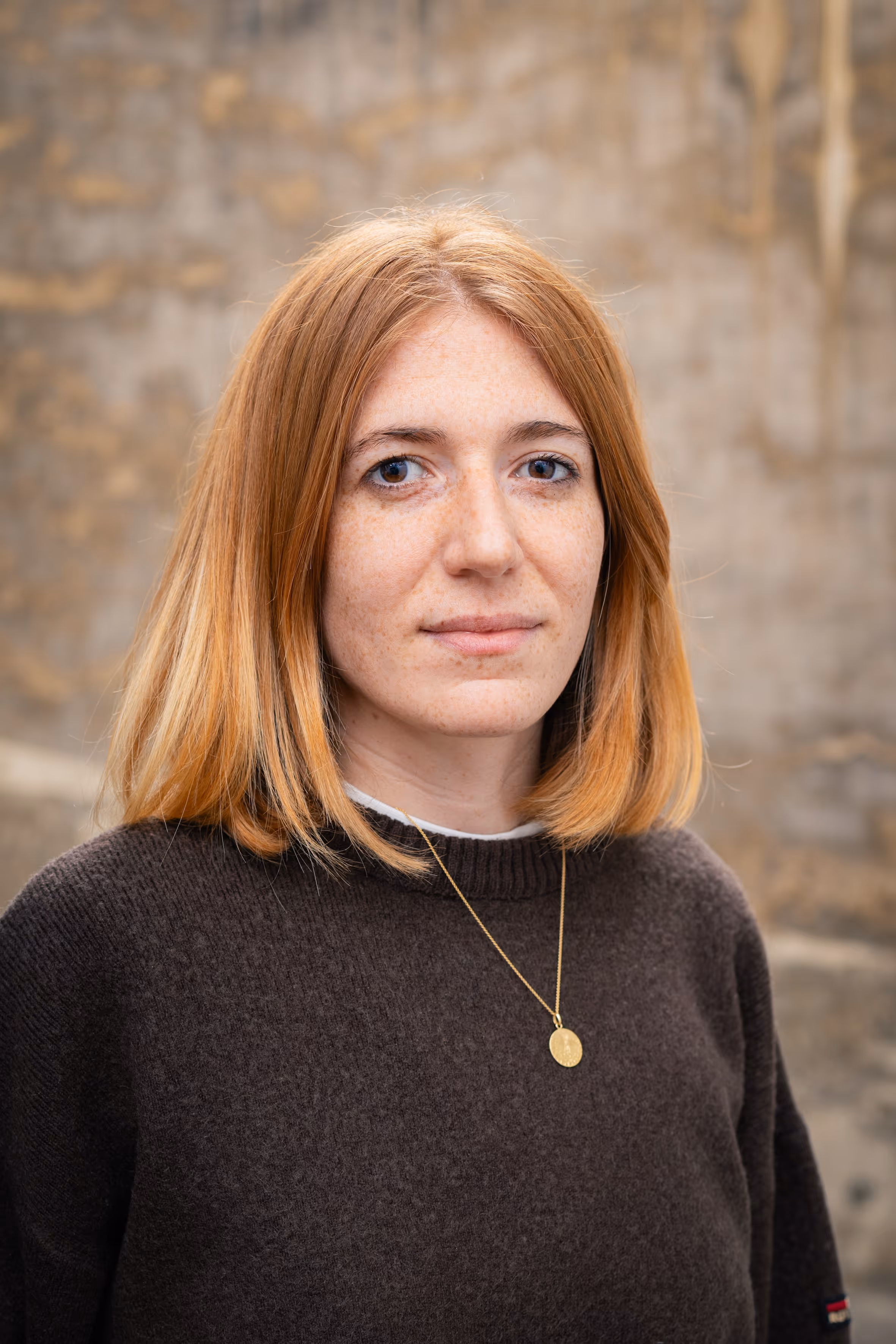 A close-up portrait of a woman smiling.