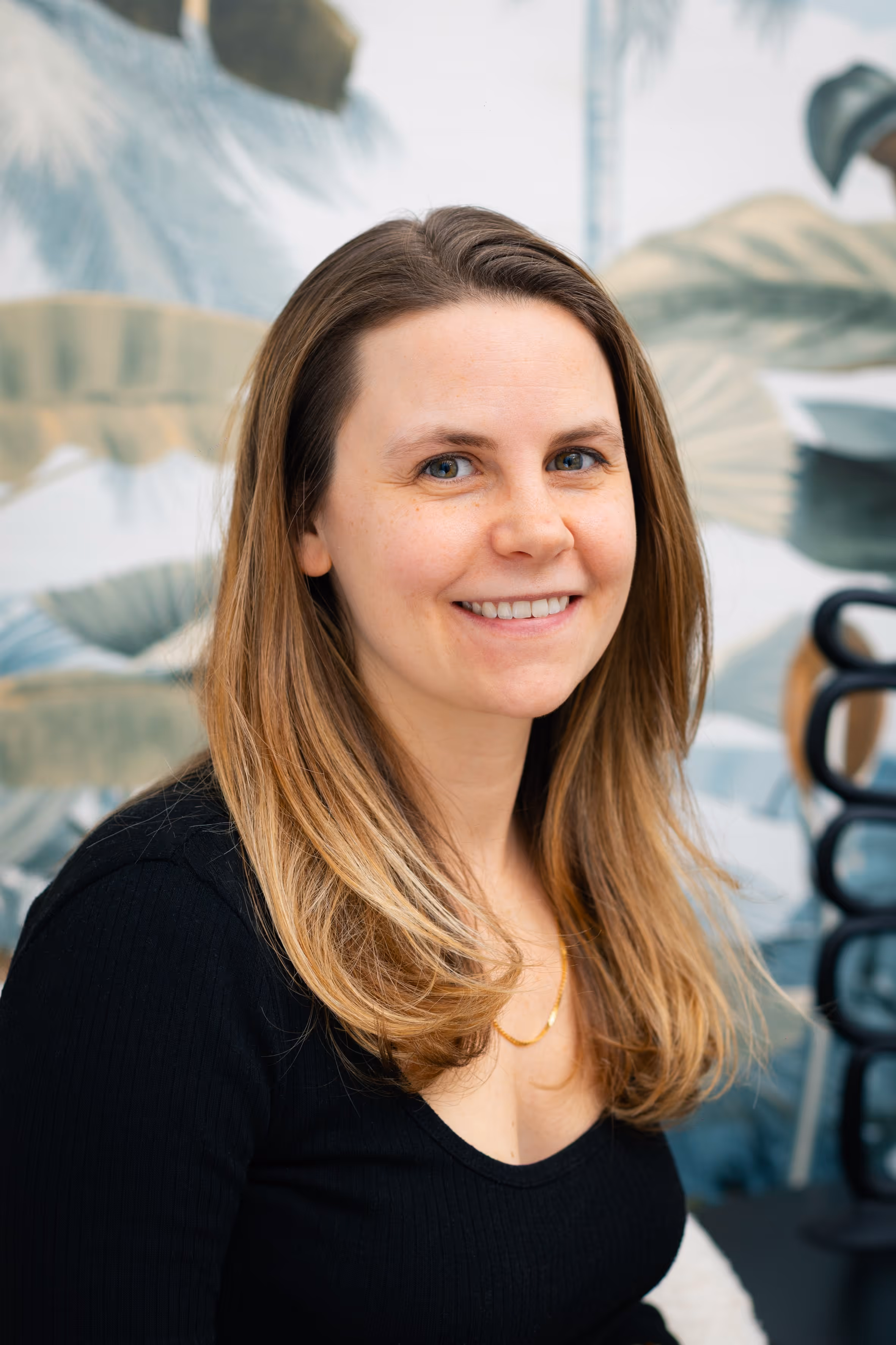 A close-u portrait of a man sitting and smiling.
